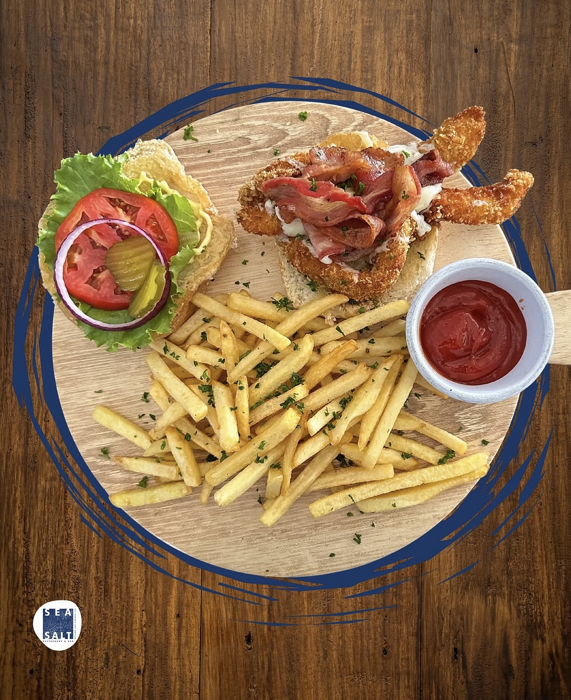 Fish and shrimp burger with fries on a wooden board