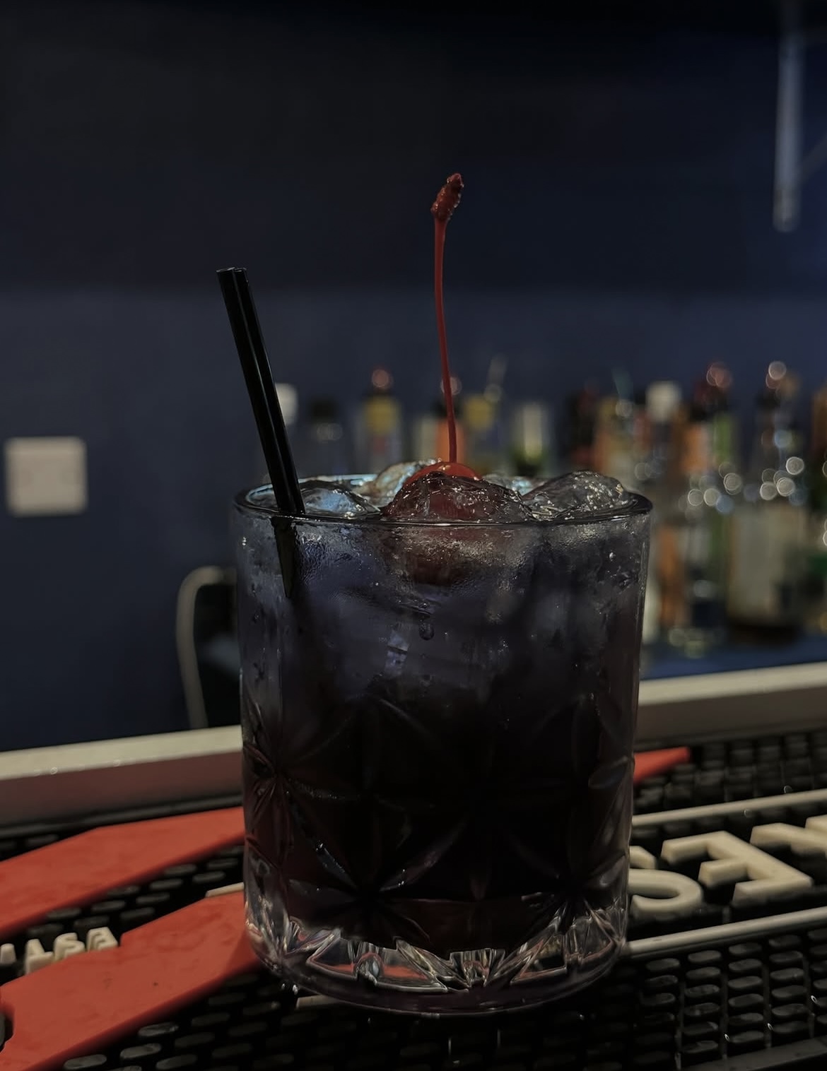 Dark cherry cocktail on the bar top