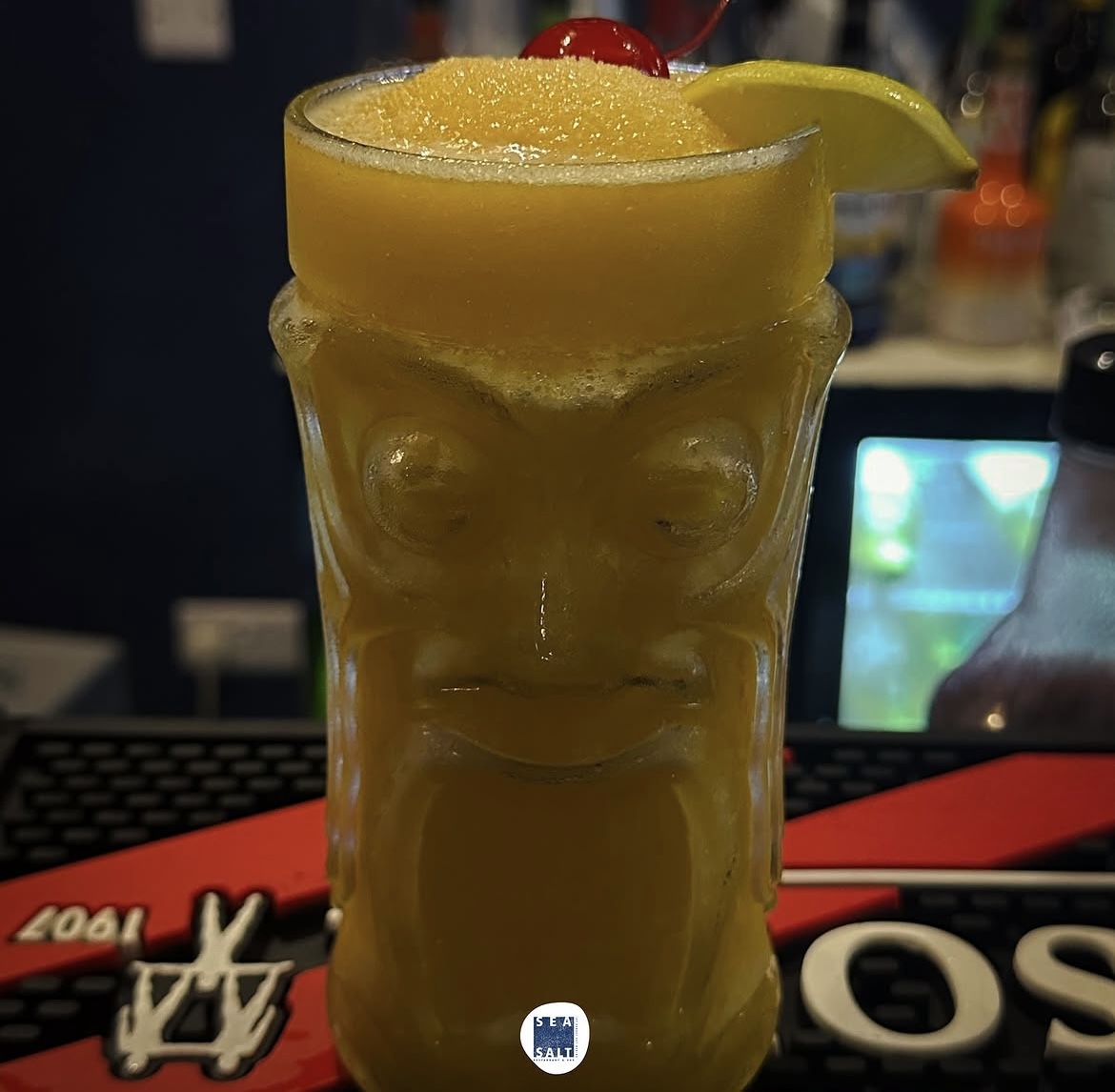 Frozen mango daiquiri in a tiki glass with a cherry