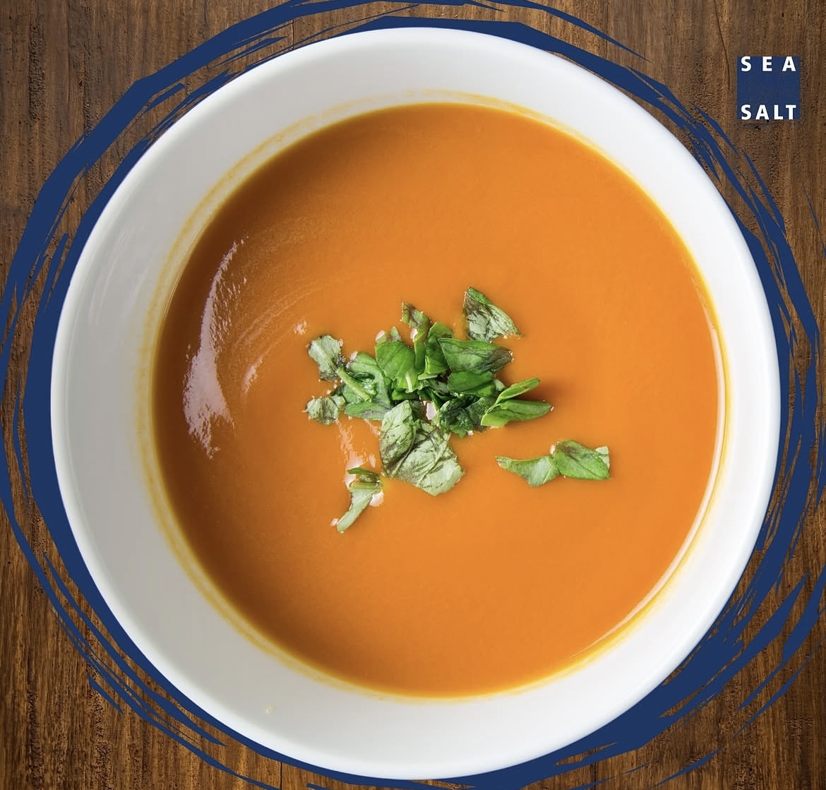 Creamy pumpkin soup topped with fresh herbs