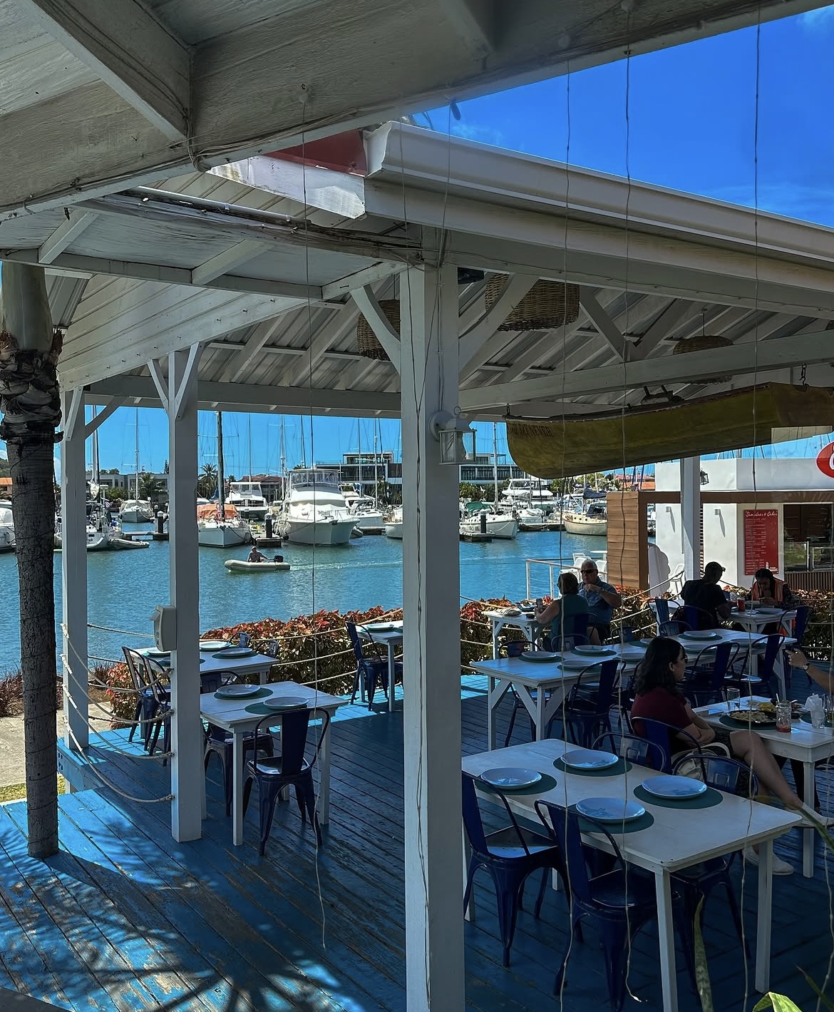 Waterfront deck seating looking out over boats in Rodney Bay Marina